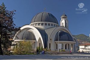 A grand white church with a domed roof, standing tall and majestic.