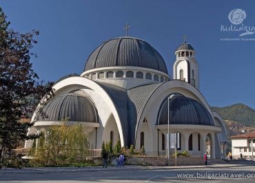 A grand white church with a domed roof, standing tall and majestic.