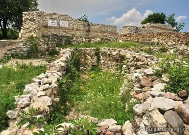 The weathered stone wall of the ancient castle stands tall, showcasing its rich history and grandeur.